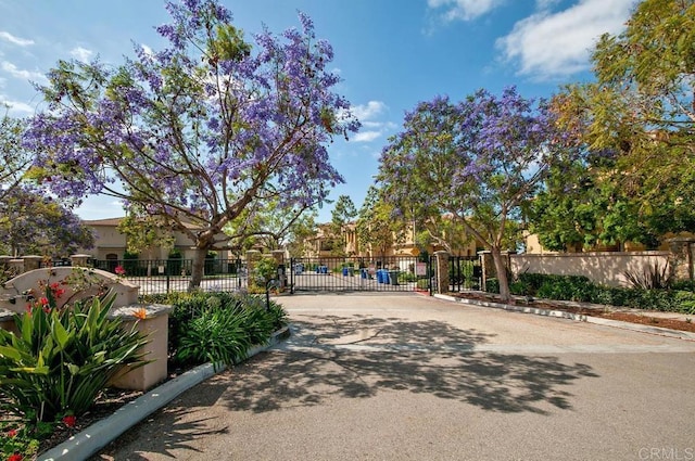 surrounding community featuring a gate and fence