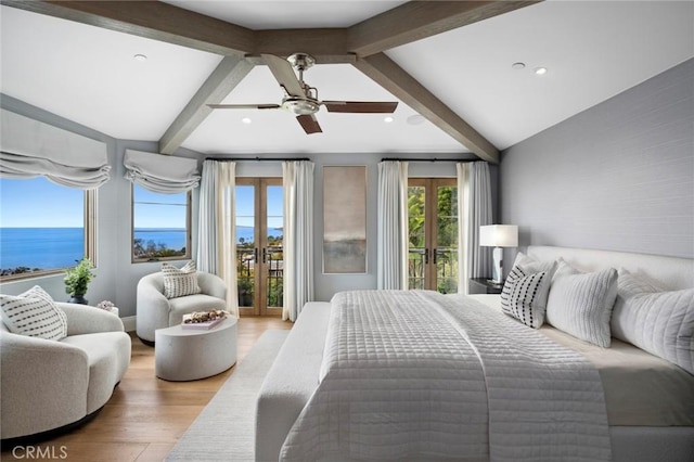 bedroom with recessed lighting, a water view, access to outside, light wood-type flooring, and french doors