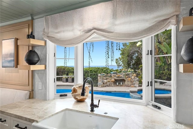 details featuring light stone countertops, white cabinets, and a sink
