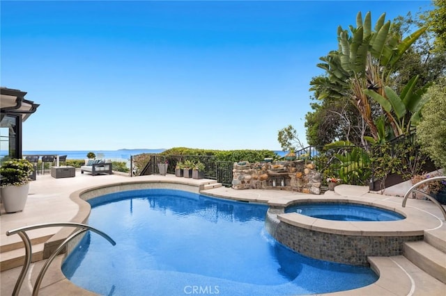 view of pool with a patio and a pool with connected hot tub
