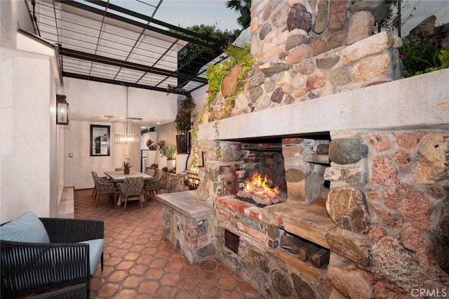 view of patio / terrace with outdoor dining area and an outdoor stone fireplace