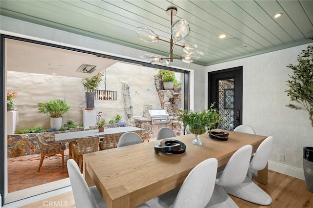 dining room with recessed lighting, an inviting chandelier, wooden ceiling, baseboards, and wood finished floors