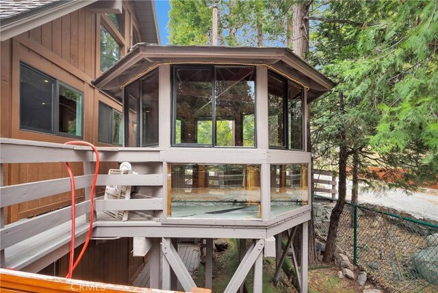 825 Grass Valley Rd, Lake Arrowhead, CA 92352 - view of property exterior featuring fence and a sunroom