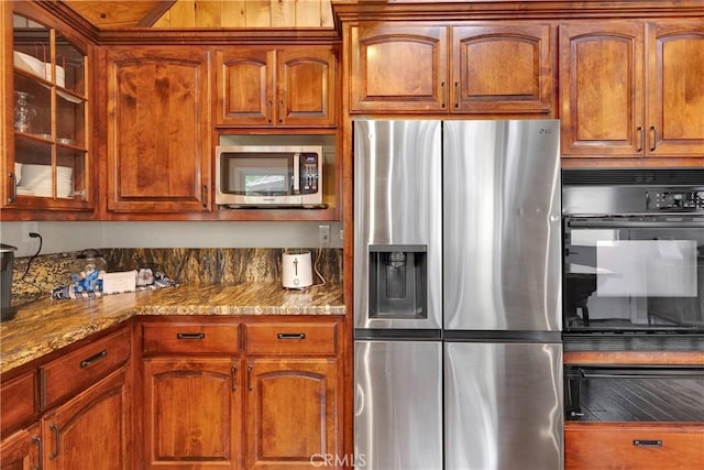 825 Grass Valley Rd, Lake Arrowhead, CA 92352 - kitchen featuring brown cabinetry, stone counters, glass insert cabinets, and appliances with stainless steel finishes