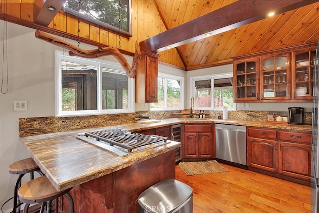 825 Grass Valley Rd, Lake Arrowhead, CA 92352 - kitchen featuring wood ceiling, appliances with stainless steel finishes, vaulted ceiling, a sink, and a peninsula