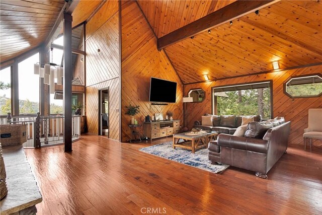 825 Grass Valley Rd, Lake Arrowhead, CA 92352 - living room featuring beam ceiling, wood walls, hardwood / wood-style flooring, and high vaulted ceiling