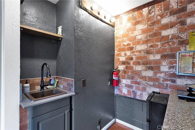 825 Grass Valley Rd, Lake Arrowhead, CA 92352 - kitchen featuring baseboards, a sink, a textured wall, and light countertops