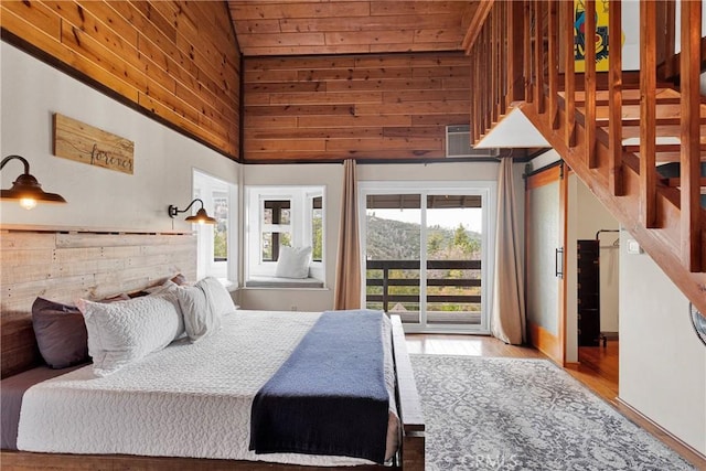 825 Grass Valley Rd, Lake Arrowhead, CA 92352 - bedroom featuring wood finished floors, wood walls, access to exterior, a wall mounted AC, and a towering ceiling