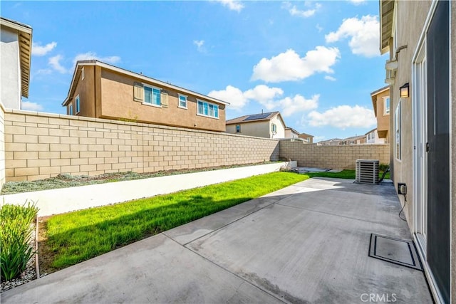 view of patio / terrace featuring cooling unit and a fenced backyard