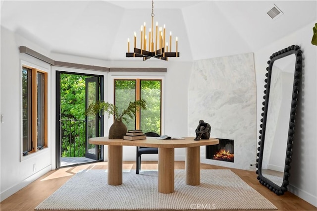 1935 Maverick Ln, North Tustin, CA 92705 - office area featuring wood finished floors, a fireplace, visible vents, a notable chandelier, and lofted ceiling