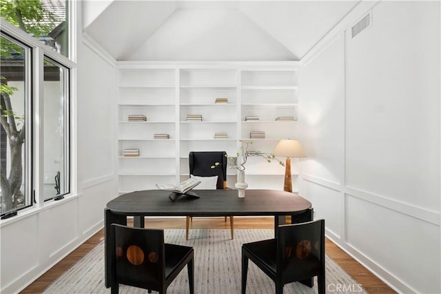 1935 Maverick Ln, North Tustin, CA 92705 - office area featuring wood finished floors, a decorative wall, visible vents, and built in shelves