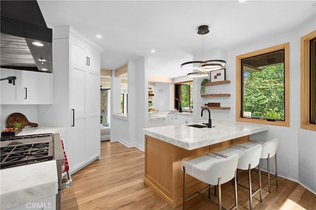 1935 Maverick Ln, North Tustin, CA 92705 - kitchen with recessed lighting, a sink, light wood-style floors, light stone counters, and white cabinetry