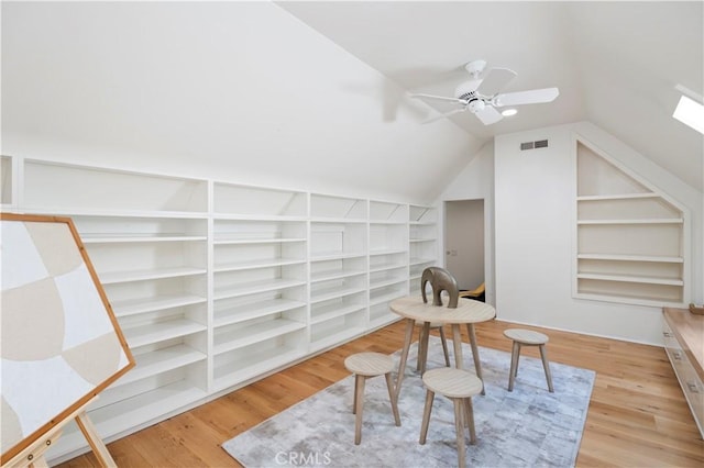 1935 Maverick Ln, North Tustin, CA 92705 - interior space featuring vaulted ceiling with skylight, visible vents, ceiling fan, wood finished floors, and built in features