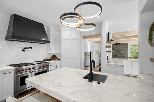1935 Maverick Ln, North Tustin, CA 92705 - kitchen with a sink, decorative backsplash, range with two ovens, premium range hood, and white cabinets