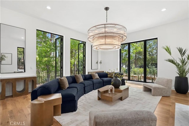1935 Maverick Ln, North Tustin, CA 92705 - living room with recessed lighting, an inviting chandelier, a wealth of natural light, and wood finished floors