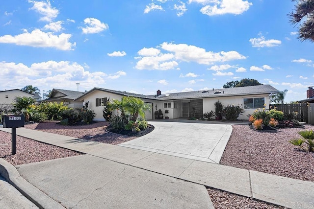 3185 Monroe St, Carlsbad, CA 92008 - ranch-style house featuring curved driveway, stucco siding, and a garage