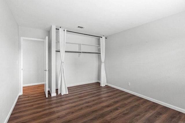 3185 Monroe St, Carlsbad, CA 92008 - unfurnished bedroom with a closet, baseboards, and dark wood-style flooring