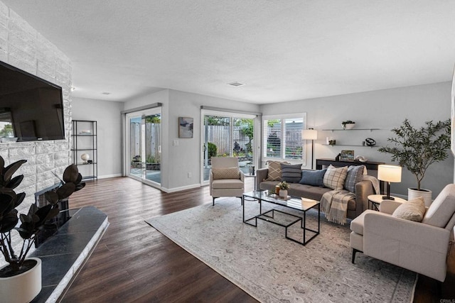 3185 Monroe St, Carlsbad, CA 92008 - living area with dark wood-style floors, baseboards, and a textured ceiling