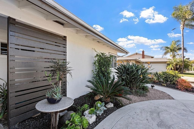 3185 Monroe St, Carlsbad, CA 92008 - view of side of home with stucco siding and a garage