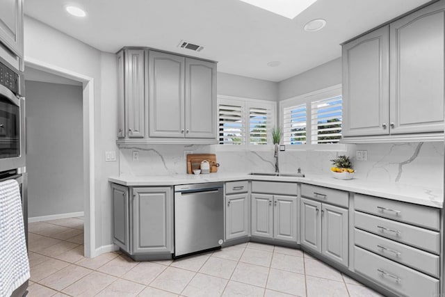 3185 Monroe St, Carlsbad, CA 92008 - kitchen with gray cabinets, stainless steel dishwasher, a sink, backsplash, and recessed lighting