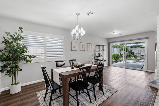 3185 Monroe St, Carlsbad, CA 92008 - dining space featuring wood finished floors, baseboards, and a chandelier