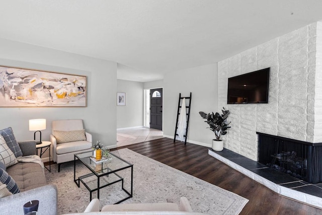 3185 Monroe St, Carlsbad, CA 92008 - living area with wood finished floors, baseboards, and a brick fireplace
