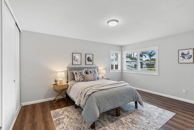 3185 Monroe St, Carlsbad, CA 92008 - bedroom with dark wood-style flooring, baseboards, and a closet
