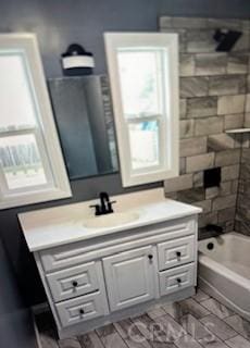 bathroom with bathing tub / shower combination and vanity
