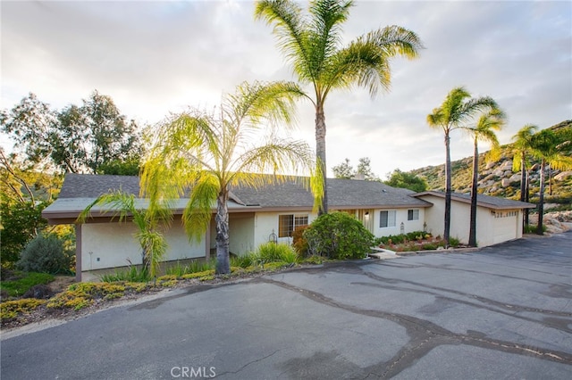 12140 Lilac Knolls Rd, Valley Center, CA 92082 - ranch-style home featuring an attached garage, driveway, and stucco siding