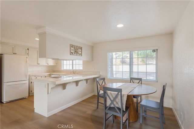 12140 Lilac Knolls Rd, Valley Center, CA 92082 - kitchen with a peninsula, white cabinets, freestanding refrigerator, and light wood-type flooring