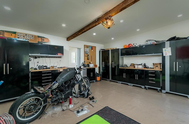interior space with a workshop area, recessed lighting, and freestanding refrigerator