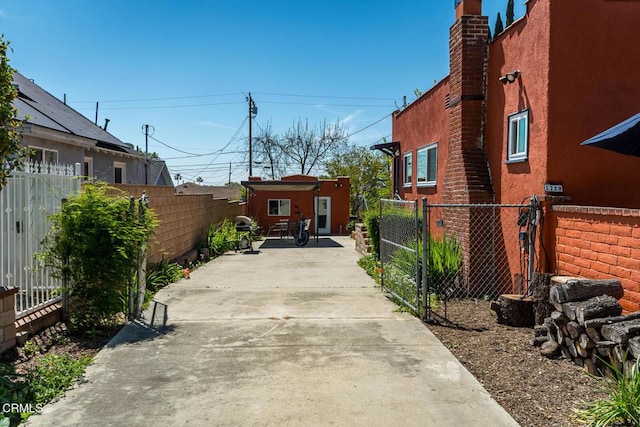 view of patio with fence and driveway
