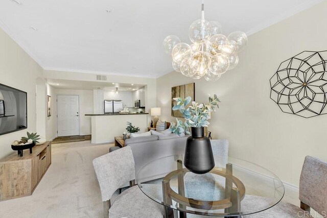 9253 Regents Unit A203, La Jolla, CA 92037 - dining area featuring light carpet, crown molding, a chandelier, and baseboards