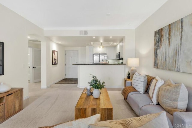9253 Regents Unit A203, La Jolla, CA 92037 - living room featuring baseboards, light carpet, arched walkways, and ornamental molding