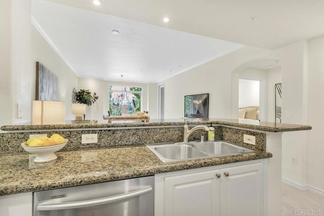 9253 Regents Unit A203, La Jolla, CA 92037 - kitchen featuring a sink, stainless steel dishwasher, white cabinetry, dark stone countertops, and arched walkways