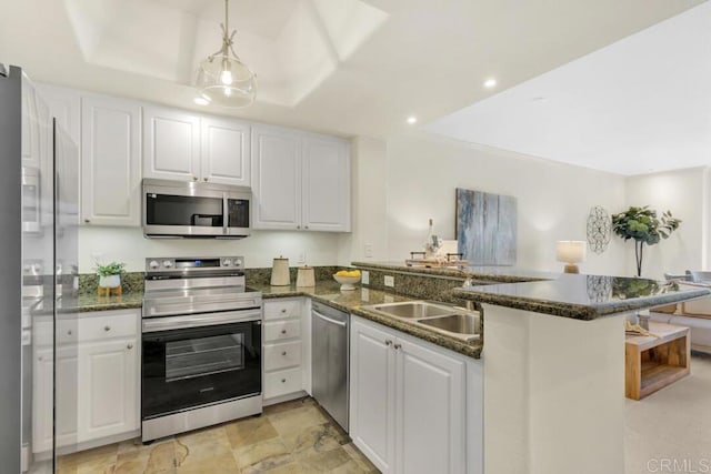 9253 Regents Unit A203, La Jolla, CA 92037 - kitchen with appliances with stainless steel finishes, a peninsula, a sink, white cabinets, and recessed lighting