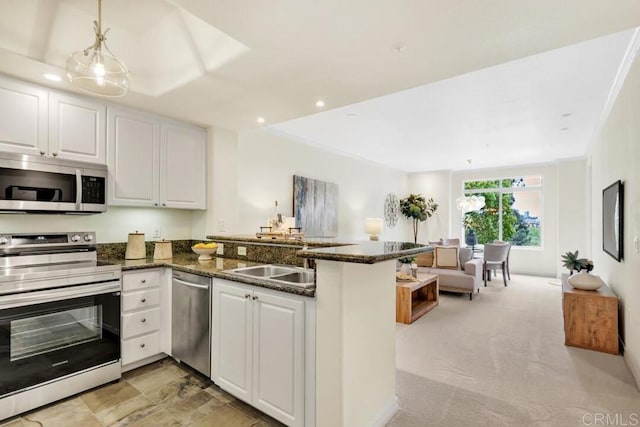 9253 Regents Unit A203, La Jolla, CA 92037 - kitchen with stainless steel appliances, a peninsula, open floor plan, white cabinetry, and recessed lighting