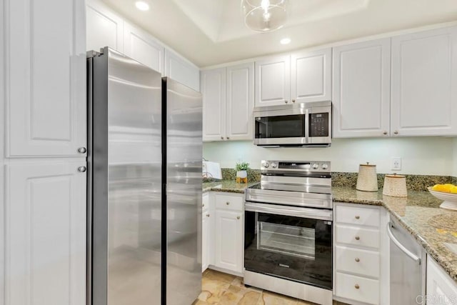 9253 Regents Unit A203, La Jolla, CA 92037 - kitchen with stainless steel appliances, white cabinetry, recessed lighting, light stone counters, and light tile patterned flooring