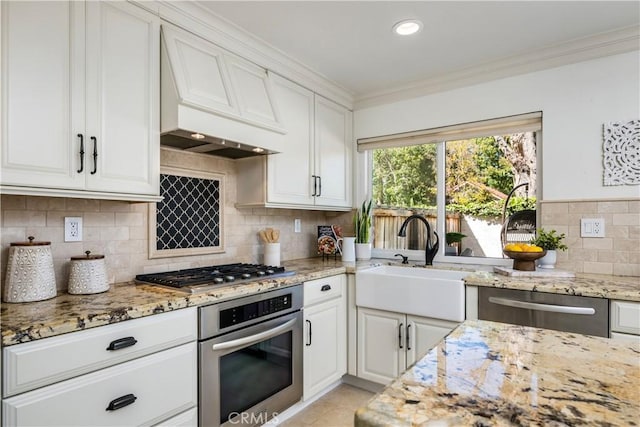 3 Terracima, Irvine, CA 92620 - kitchen featuring appliances with stainless steel finishes, a sink, white cabinets, custom exhaust hood, and ornamental molding