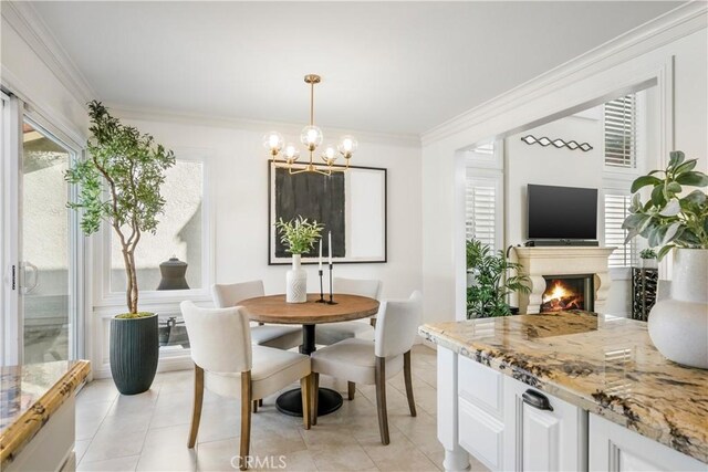 3 Terracima, Irvine, CA 92620 - dining room with a lit fireplace, an inviting chandelier, ornamental molding, and light tile patterned floors
