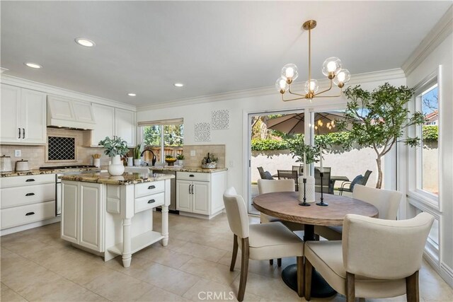 3 Terracima, Irvine, CA 92620 - kitchen featuring white cabinets, light stone countertops, a chandelier, decorative backsplash, and custom exhaust hood