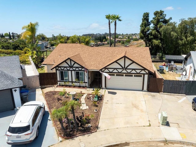 view of front facade featuring a garage, fence, a gate, and driveway