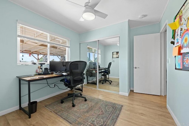 office area with wood finished floors, ceiling fan, crown molding, and baseboards