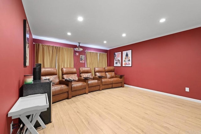 cinema room featuring light wood-style floors, recessed lighting, and ornamental molding