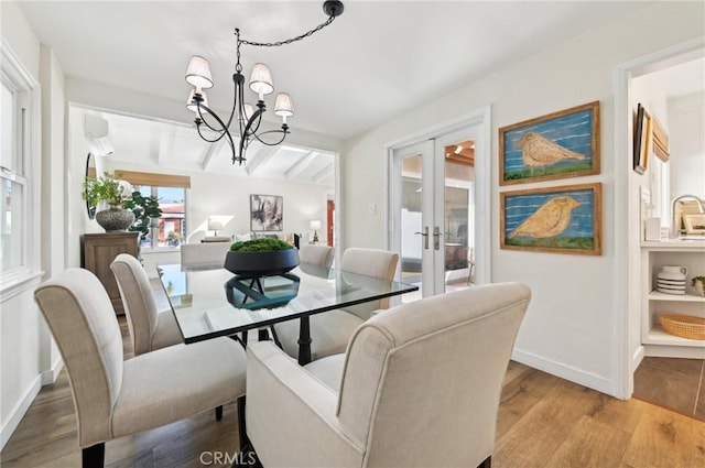 67 Corona Ave, Long Beach, CA 90803 - dining area featuring a notable chandelier, baseboards, french doors, and light wood-type flooring