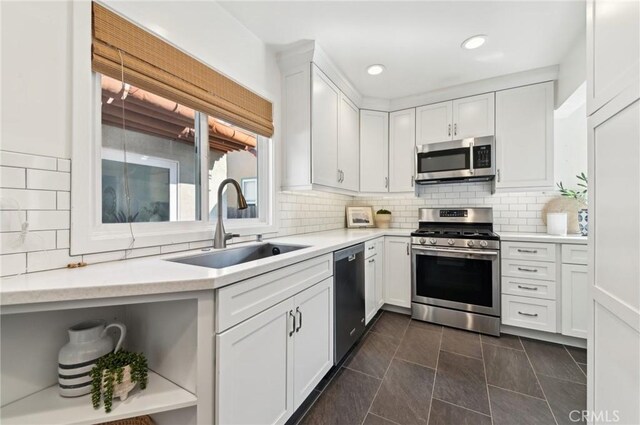 67 Corona Ave, Long Beach, CA 90803 - kitchen featuring open shelves, appliances with stainless steel finishes, light countertops, a sink, and white cabinetry