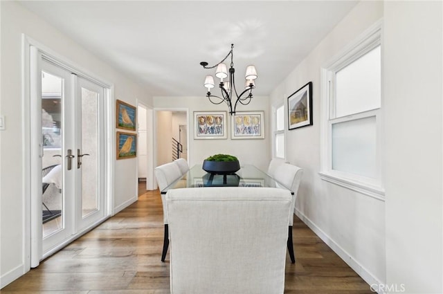 67 Corona Ave, Long Beach, CA 90803 - dining room with wood finished floors, a chandelier, and baseboards