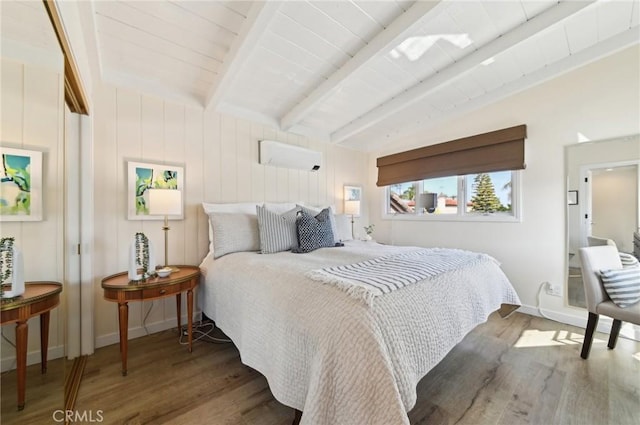 67 Corona Ave, Long Beach, CA 90803 - bedroom featuring wood finished floors, a wall unit AC, vaulted ceiling with beams, and baseboards