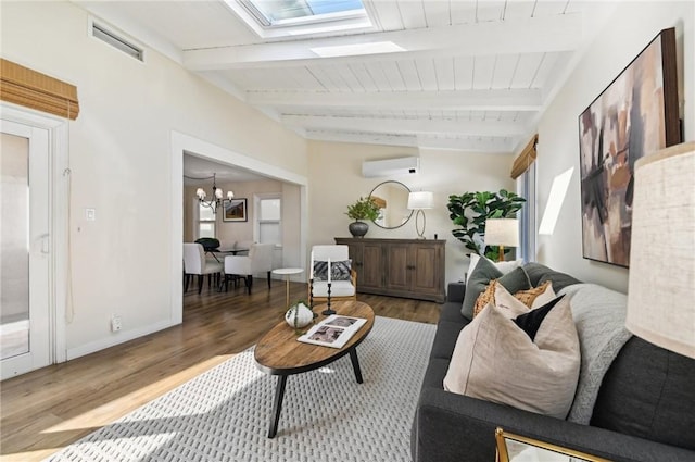 67 Corona Ave, Long Beach, CA 90803 - living room featuring visible vents, a wall unit AC, wood finished floors, and a skylight