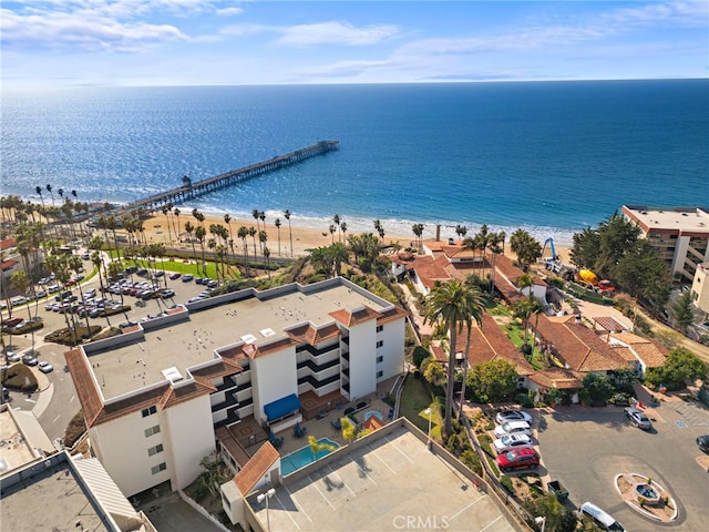 birds eye view of property featuring a water view and a view of the beach